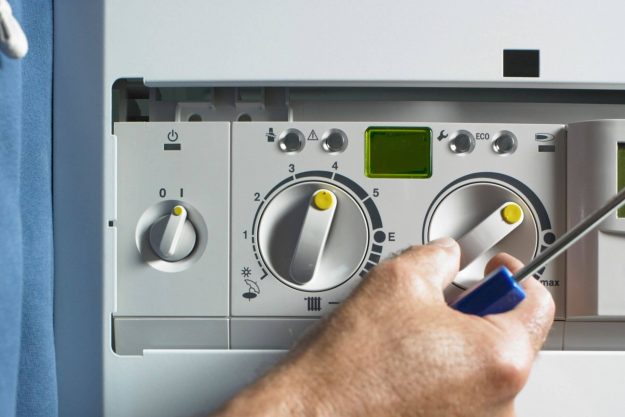 engineer fixing lpg boiler